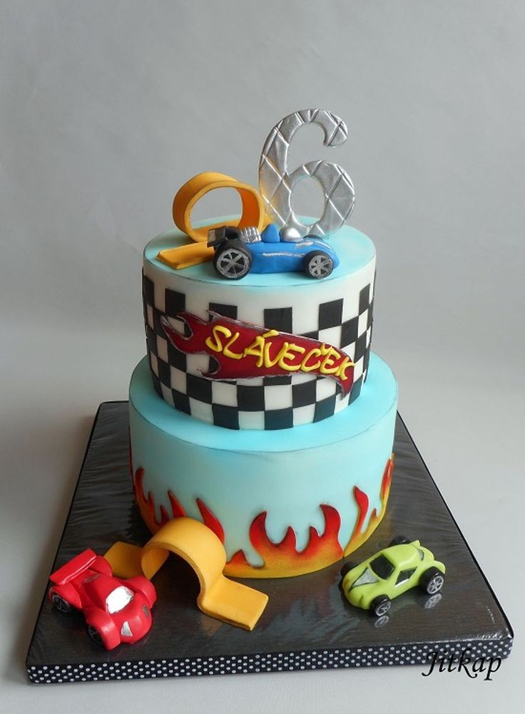 a birthday cake with cars on top and flames around the edges that spell out race