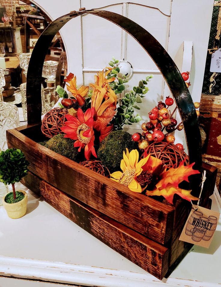 a wooden box filled with fake flowers and plants