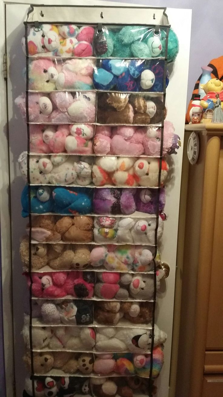 a rack filled with lots of stuffed animals next to a wall mounted radiator