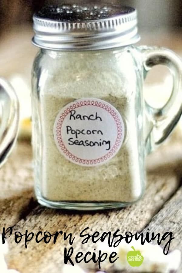 a glass jar filled with white seasoning sitting on top of a wooden table