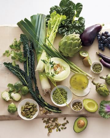 an assortment of vegetables are displayed on a cutting board