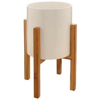 a white planter with wooden legs on a white background