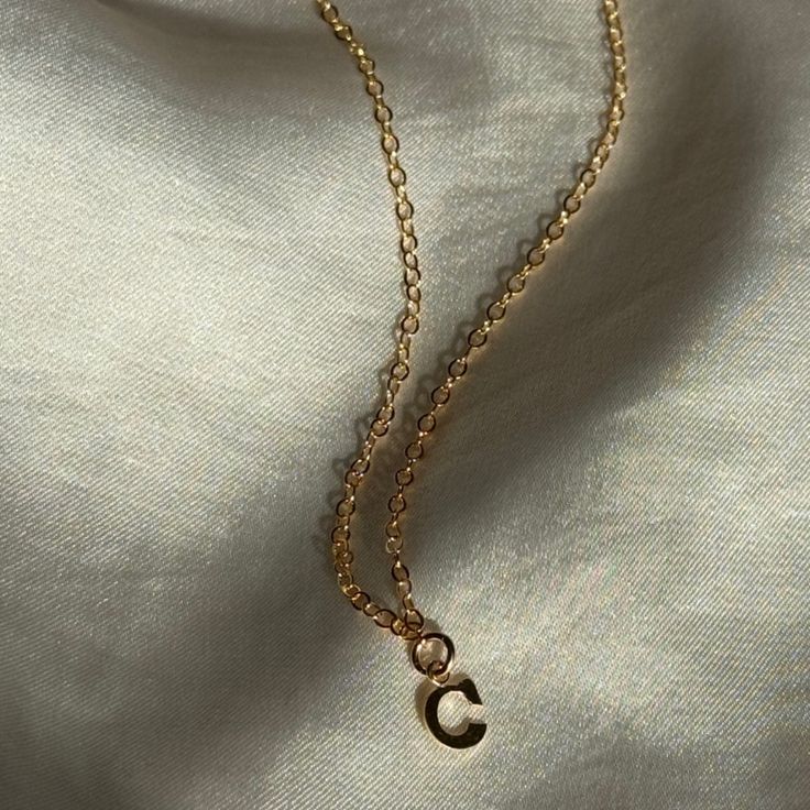 Add an extra layer of excitement to your outfit with a personalized initial necklace. Layer it with your favorite necklace for the ultimate stacking look. Material: 14K gold filled Length: 16" Comes with a 2 inch extender This is a Pre-order item and will ship within 5-7 business days. Dainty Adjustable Initial Necklace For Everyday, Minimalist Gold Initial Necklace With Paperclip Chain, Simple Gold Charm Necklace 14k Gold Filled, Dainty 14k Yellow Gold Filled Initial Necklace, Everyday 14k Gold Filled Initial Pendant Necklace, Simple Gold Charm Necklace In 14k Gold Filled, Everyday 14k Gold Filled Initial Necklace, Dainty Everyday Initial Necklace Tarnish Resistant, Dainty 14k Gold Filled Name Necklace