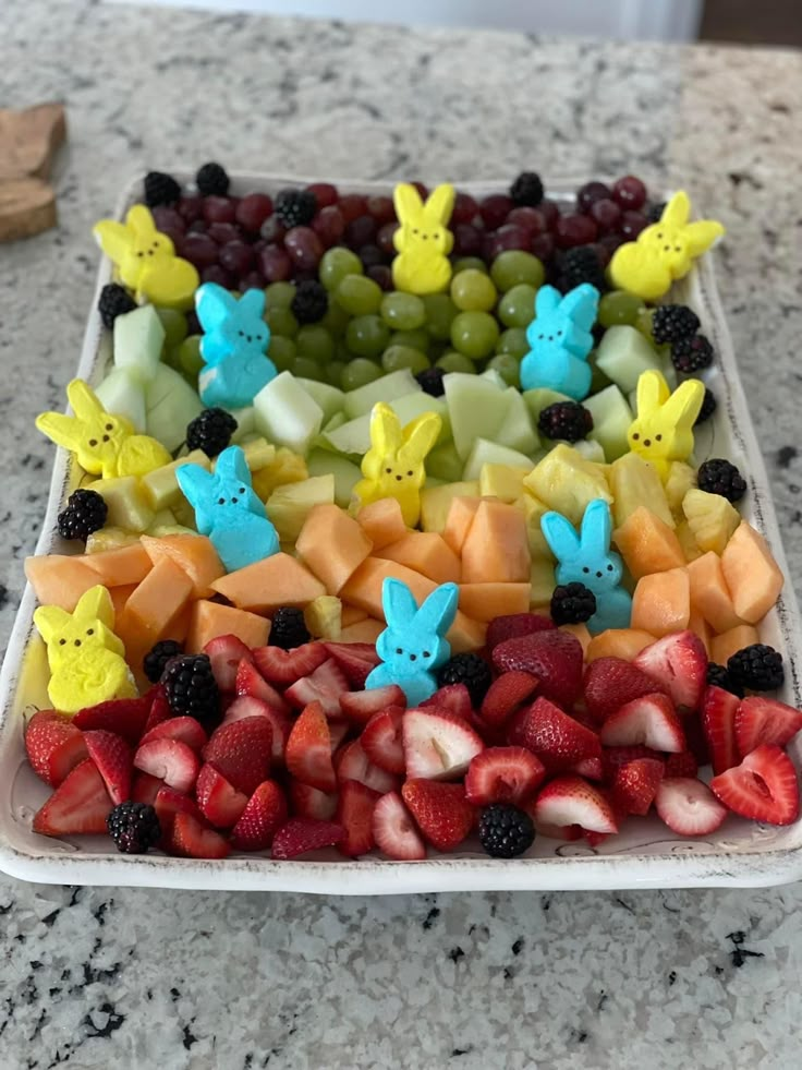 a platter filled with different types of fruits and veggies in the shape of bunnies