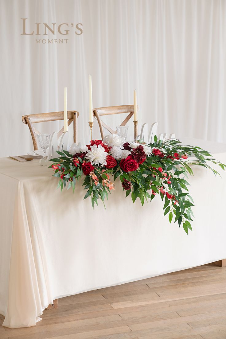 the table is decorated with flowers and candles