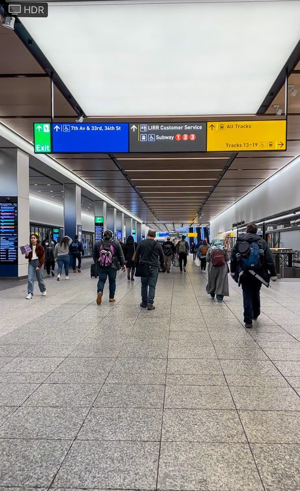 many people are walking through an airport terminal