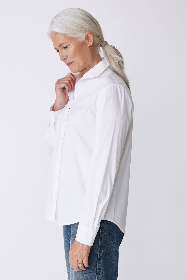 With a tailored look yet an ease of fit, our Box Pleat Ginna shirt is made for women on the move. A unique single piece collar construction can be worn up or softly folded befitting your mood. Back box pleat, center front exposed button closure, classic cuff length, sleeve placket detail, and signature loop detail. - 83% Cotton, 14% Polyamide, 3% Elastin - Made in NYC - Dry clean or machine wash - Our model is 5'9.5" wearing size 4 - Chest Width 40", Hip Width 45", Length 28" Orders are processed within three business days (not including weekends or holidays). All pre-orders are charged at the time of purchase and shipped on the date indicated on each style. All returns are subject to a per order restocking fee. Please visit the RETURNS/EXCHANGES page to review our policies regarding retur Timeless Spread Collar Top For Daywear, Timeless Daywear Top With Spread Collar, Timeless Top With Spread Collar For Daywear, Chic Everyday Shirt With Collared Neckline, Classic Top With Fold Down Collar For Daywear, Classic Tops With Fold Down Collar For Daywear, Classic Collared Tops For Daywear, Modern Fitted Blouse With Shirttail Hem, Fitted Top With Button Cuffs For Everyday