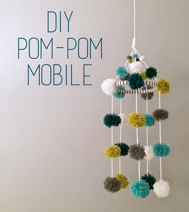 a mobile with pom - pom balls hanging from it's sides and the words diy pom - pom mobile above it