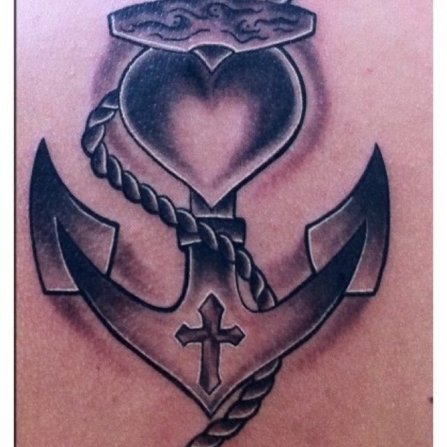 a heart and anchor tattoo on the back of a man's chest, with an anchor in the middle