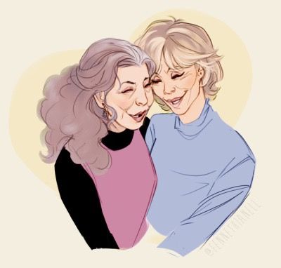 two older women hugging each other while smiling