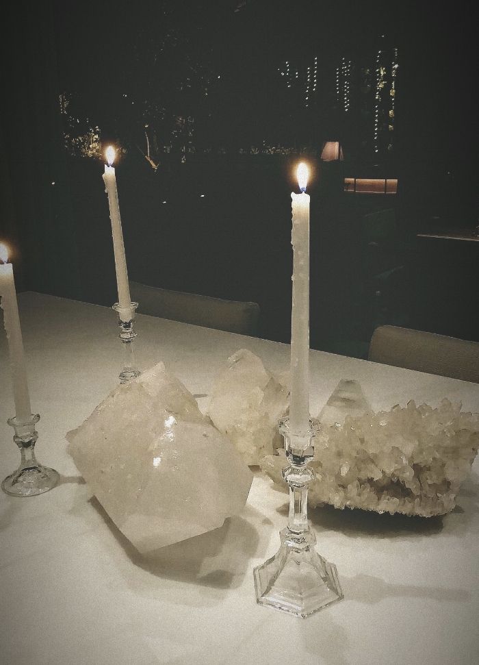 some candles are sitting on a table with crystals