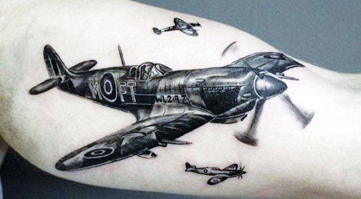 an old airplane tattoo on the arm