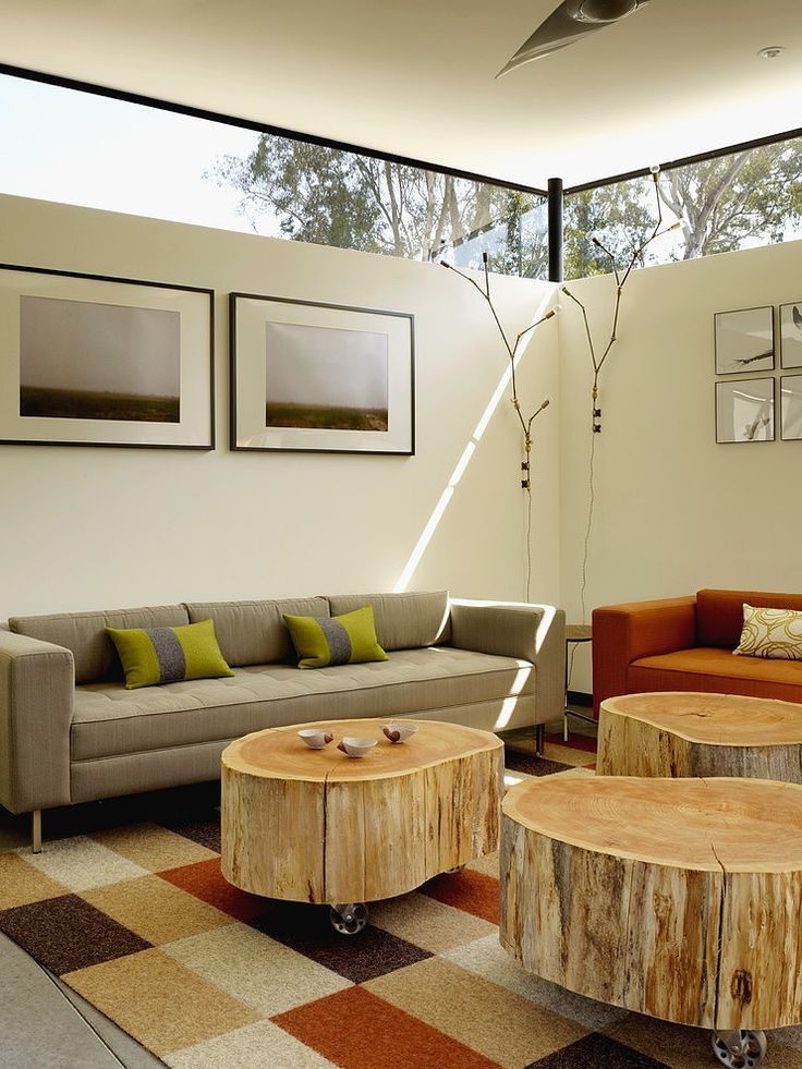 a living room with couches, tables and pictures on the wall