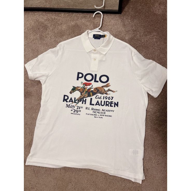 This Polo Ralph Lauren Shirt In Size Xl Features A Classic Fit With A Collared Neckline And Short Sleeves. Made Of 100% Cotton, It Has A White Base Color With A Graphic Print Of A Big Horse And The Words "Polo Golf" On The Front. The Shirt Is Part Of The Ralph Lauren Polo Golf Product Line And Has A Theme Of Equestrian Riding Academy. Perfect For Golfers Or Anyone Who Loves The Iconic Polo Ralph Lauren Brand, This Shirt Is In Excellent Shape And Ready To Wear. The Shirt Was Manufactured In The P Classic Collared Tops With Logo Print, Classic Collared Top With Logo Print, Classic Polo Collar Top With Logo Print, Classic Collared Shirt With Logo Print, Casual Golf Polo Shirt With Graphic Print, Classic Collared Top With Graphic Print, Classic Polo Collar Top With Graphic Print, Classic Fitted Polo Shirt With Graphic Print, Cotton Golf Top With Logo Print