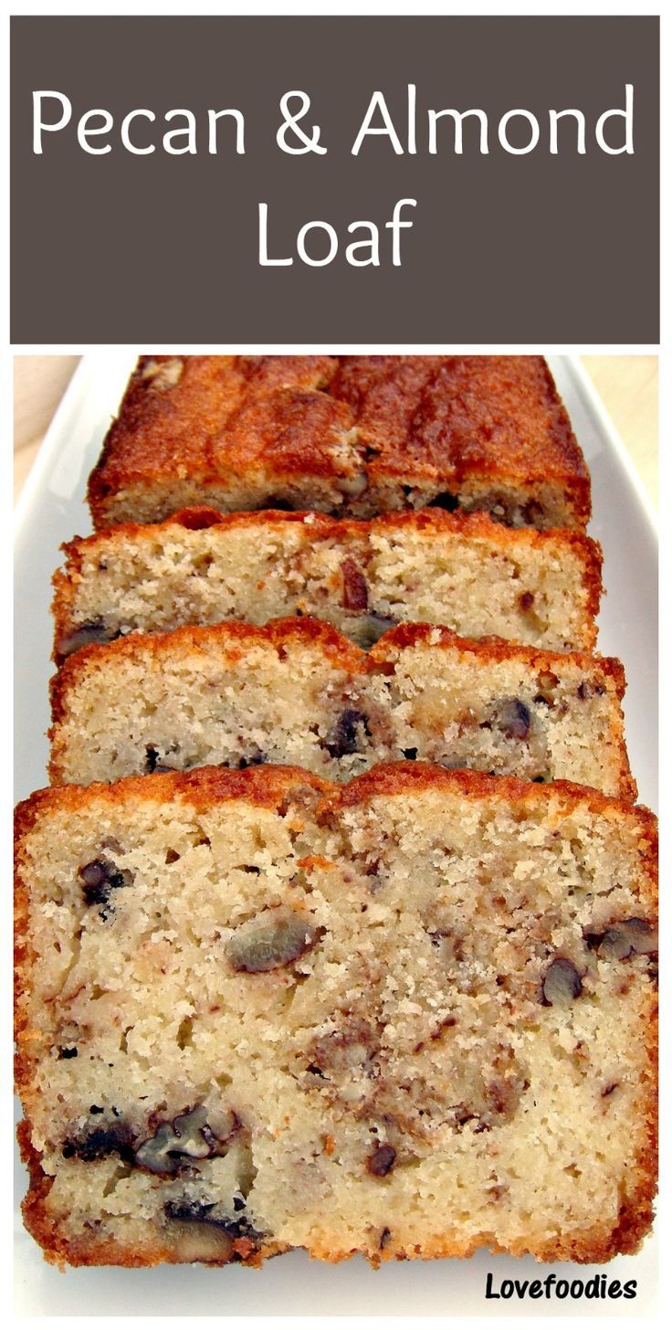 sliced loaf of pecan and almond loaf on a white plate with text overlay