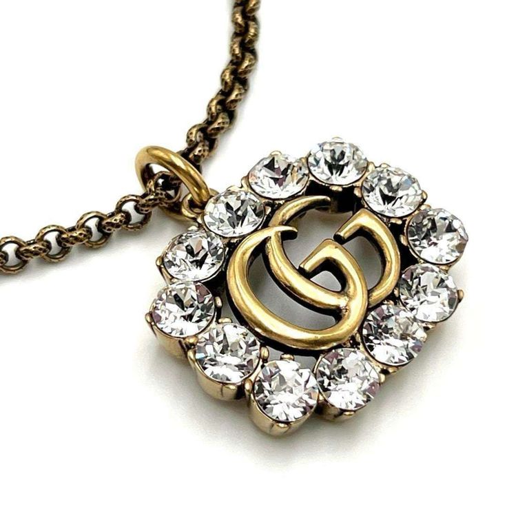 Used Gucci Necklace Pendant Crystal Double G (Sku: Gzl134t1) === General === Brand : Gucci === Design === Necklace Type : Necklace Pendant Type : Pendant Gender : Women Material : Metal, Rhinestone Color : Gold === Size === Neck Circumference : 44 Cm - 49 Cm / 17.32'' - 19.29'' === Included Items === Accessories : None Accessories Notice : Before Purchasing, Please Refer To The Images Of The Accessories Included With The Item. === Condition === Condition : Used (Like New) Ranking : Rank S Used - Gucci White Gold Jewelry With Diamond Accents, Gucci Jewelry With Diamond Accents For Gift, Gucci Fine Jewelry With Diamond Accents, Gucci Diamond Jewelry With Diamond Accents, Luxury Necklace With Logo Charm For Formal Occasions, Luxury Formal Necklace With Logo Charm, Designer Pendant Necklace With Logo Charm, Luxury White Gold Jewelry With Logo Charm, Designer Gold Necklaces For Anniversary