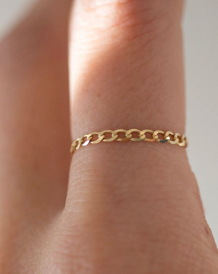 Shinny flat cuban chain ring in 14k gold This ring is more than just a piece of jewelry- it's a luxurious way to add some shine to your ensemble. Made from high-quality 14k gold, it's designed to last and to elevate your style. Perfect as a stacking ring or by itself. 14k solid yellow gold Dainty Cuban Link Curb Chain Jewelry, 14k Gold Dainty Curb Chain Jewelry, 14k Gold Cuban Link Jewelry With Adjustable Chain, Yellow Gold Chain Link Ring With Curb Chain Detail, 14k Gold Chain Ring Fine Jewelry, 14k Yellow Gold Chain Link Ring, 14k Gold Chain Ring Tarnish Resistant, Everyday 14k Gold Curb Chain Jewelry, 14k Gold Cuban Link Curb Chain Jewelry