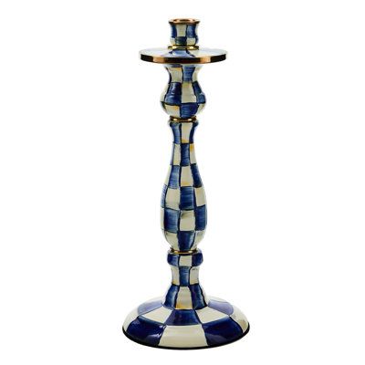 a blue and white checkerboard candle holder on a white background with a gold rim