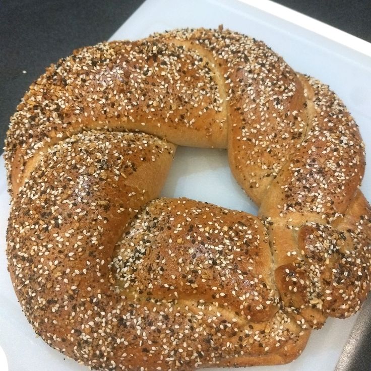 a sesame seed bagel on a cutting board