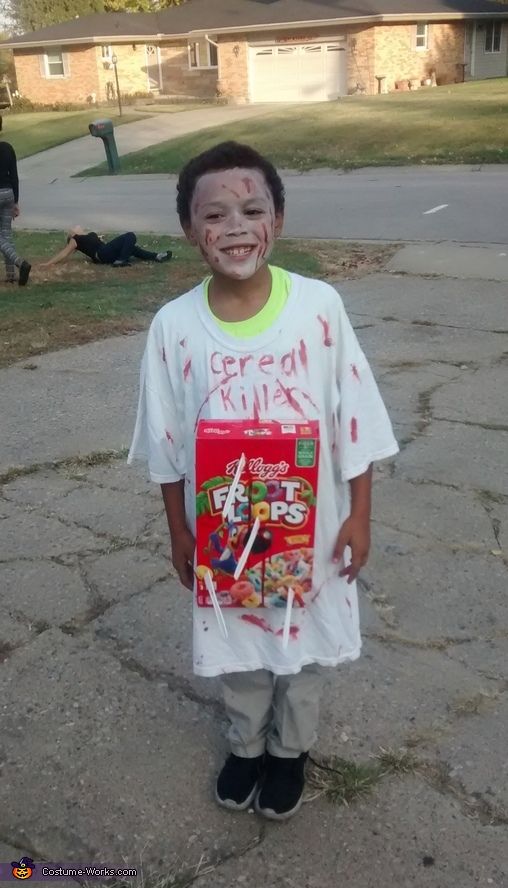 a young boy with his face painted like cereal box and the words cereal king on it