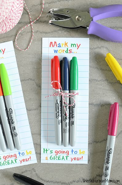 three markers and some scissors on a table