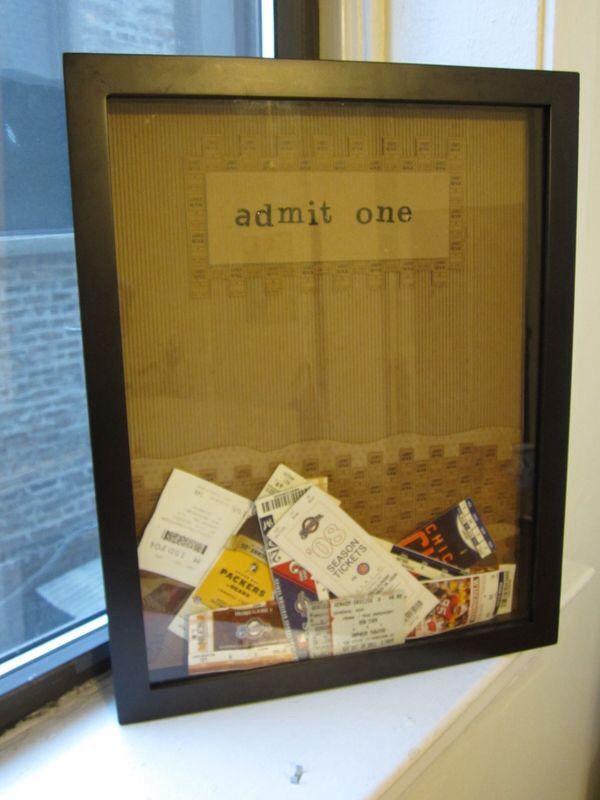 there is a framed photo with the words admit one on it and many other pieces of paper