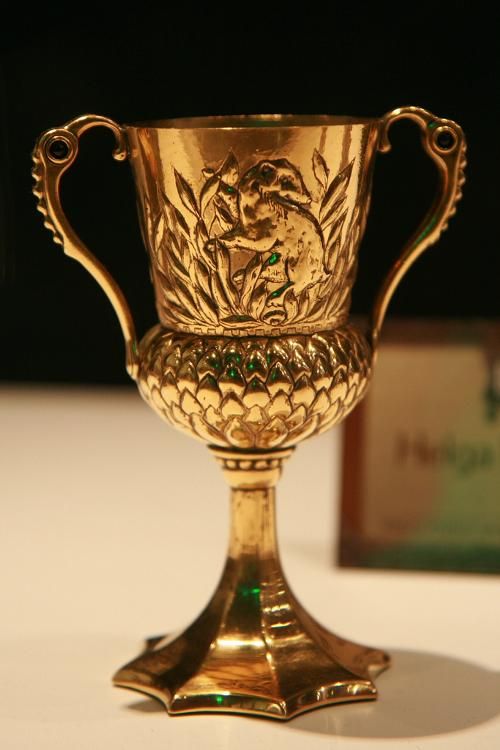 a golden cup sitting on top of a table