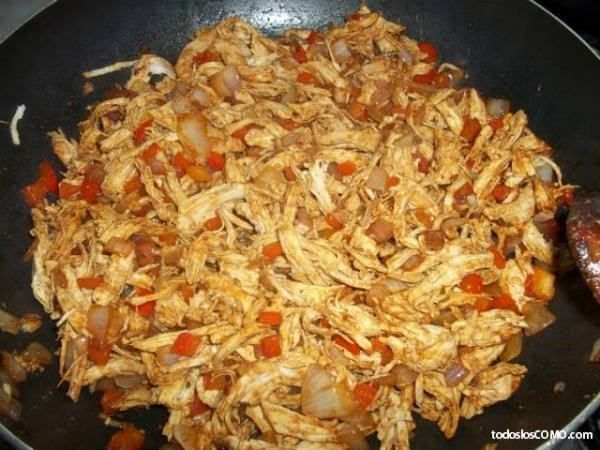 a frying pan filled with chicken and vegetables