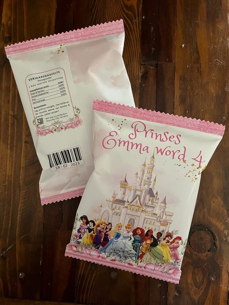 two bags with princesses on them sitting next to each other in front of a wooden wall