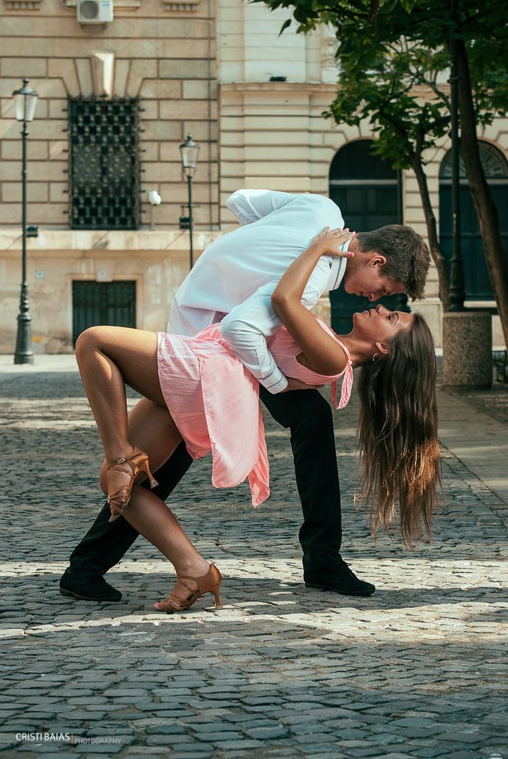 a man and woman kissing on the street