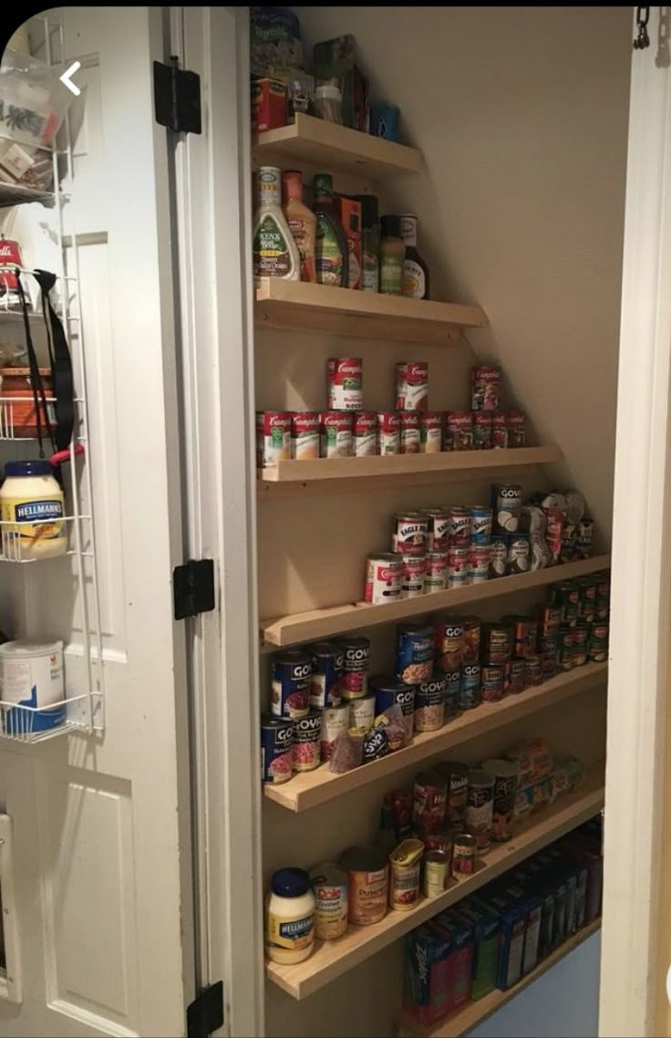 an open pantry door with shelves full of food