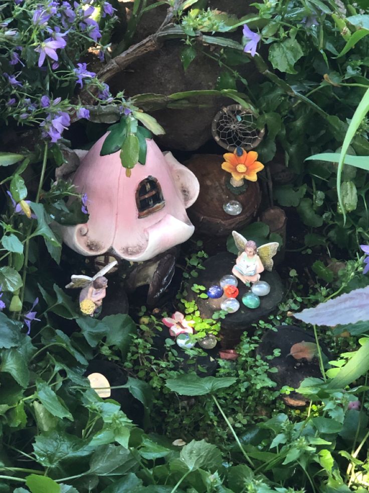 a fairy house in the middle of some plants