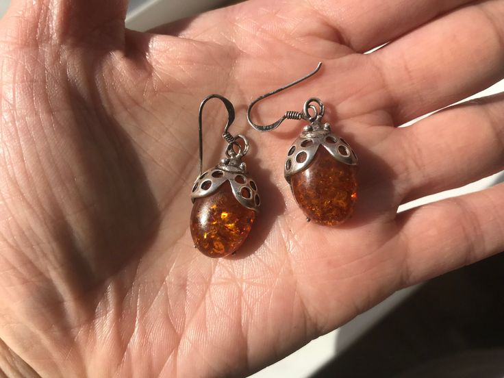 "Amber Ladybug sterling silver earrings, Intriguing Organic Gem Vintage fine sterling silver depicting the adorable little ladybugs with pierced details.  Ladybug's bodies are the honey ambers and we love that natural organic gems of these ambers with inclusions from many many years of collection. The Amber stones have amazing million history of collection that created these special gems.    Amber is November birth stone. Condition of the earrings are still good with some natural aged patina on Silver Baltic Amber Earrings, Amber Sterling Silver Hypoallergenic Earrings, Hypoallergenic Sterling Silver Amber Earrings, Hypoallergenic Amber Sterling Silver Earrings, Vintage Sterling Silver Hypoallergenic Earrings, Vintage Hypoallergenic Sterling Silver Earrings, Hypoallergenic Vintage Sterling Silver Earrings, Shoe Pendant, Insect Jewelry