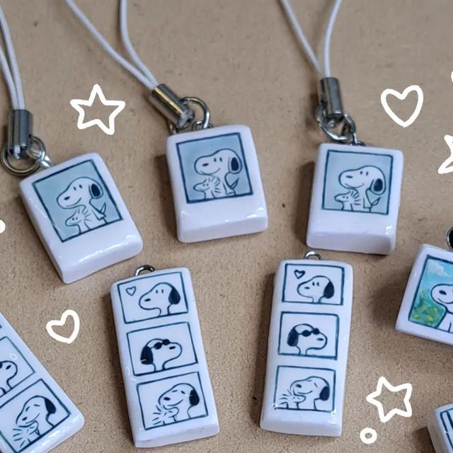 four different necklaces with pictures of dogs on them and hearts in the sky above