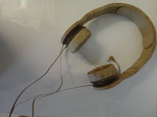 an old wooden headphone is on display in a glass case with wires attached to it