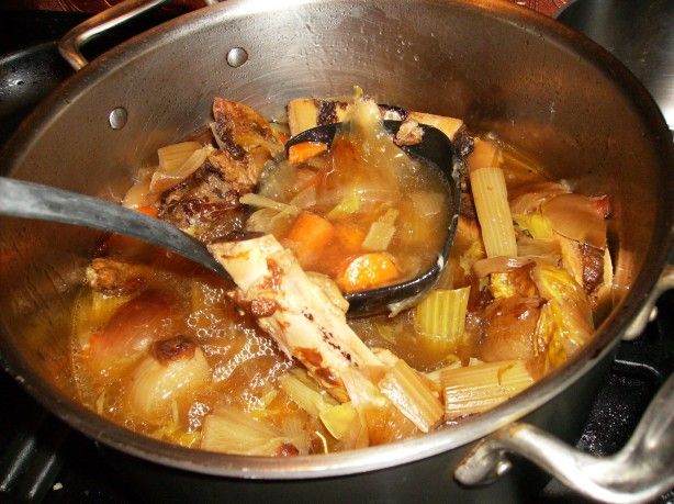 a pot filled with food sitting on top of a stove