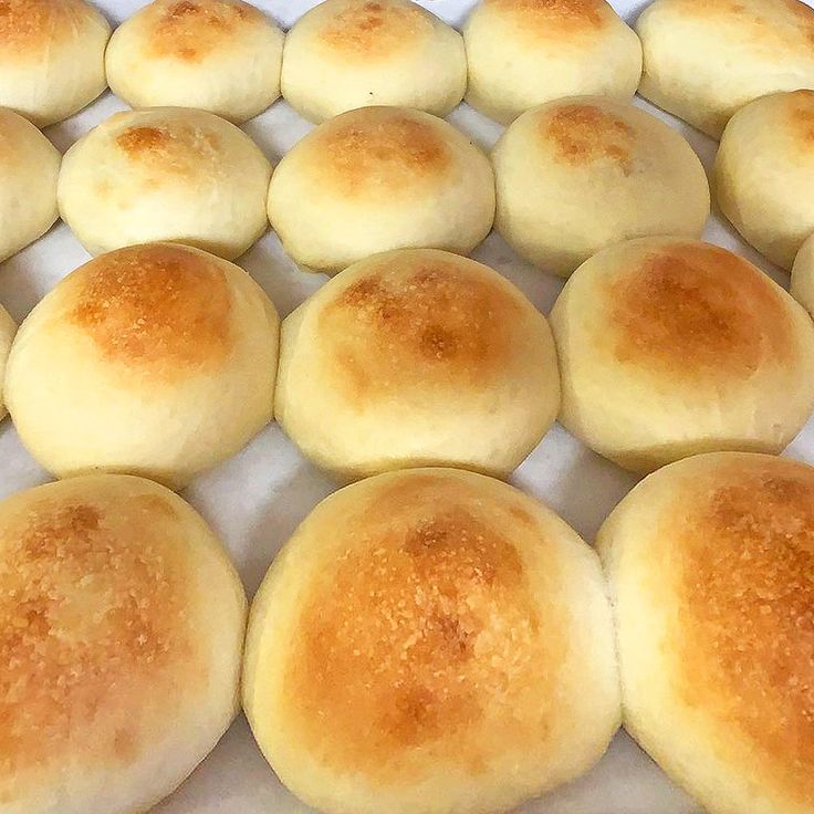 the buns are lined up in rows and ready to be baked