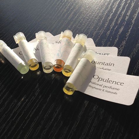 several vials are lined up next to each other on a table with paper labels