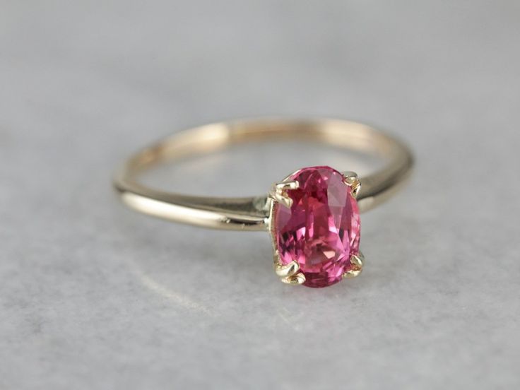 Truly all about the stone, this traditional, yellow gold mounting frames the stone perfectly while holding it securely with four split prongs. The center pops with an amazing pink color and is adorned with an expertly cut pink sapphire. Metal: 14K Yellow Gold Gem: Pink Sapphire 1.17 Carats Gem Measurements: 5 x 7.5 mm, Oval Ring Size: 5.75 Marks: "14" Stamped on the inside band Pink Ruby Ring With Accent Stones For Formal Occasions, Formal Pink Ruby Ring With Accent Stones, Pink Ruby Ring Fine Jewelry Birthstone, Heirloom Pink Jewelry With Center Stone, Pink Formal Birthstone Ring, Formal Pink Birthstone Ring, Pink Ruby Ring With Center Stone Fine Jewelry, Pink Ruby Rings With Prong Setting, Classic Pink Ruby Ring With Brilliant Cut