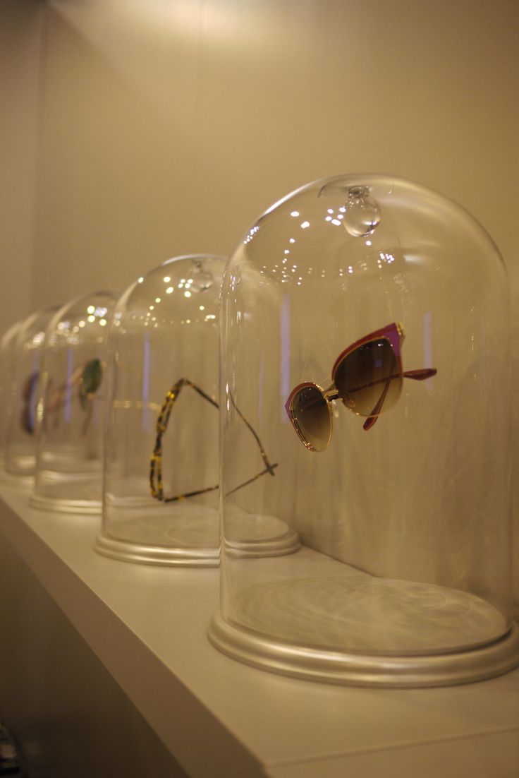 there are many glasses under the covers on this display case that is filled with sunglasses