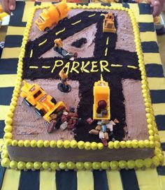 a birthday cake with construction vehicles on it