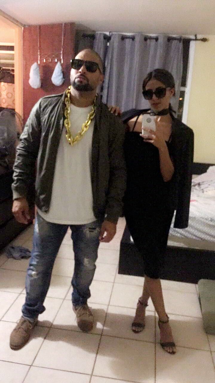 the man and woman are taking a selfie in front of their bed room mirror