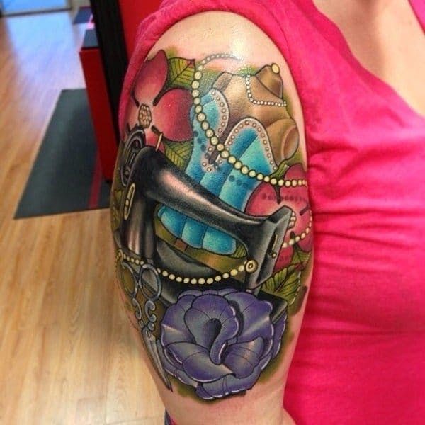 a woman wearing a pink shirt has a colorful tattoo on her arm