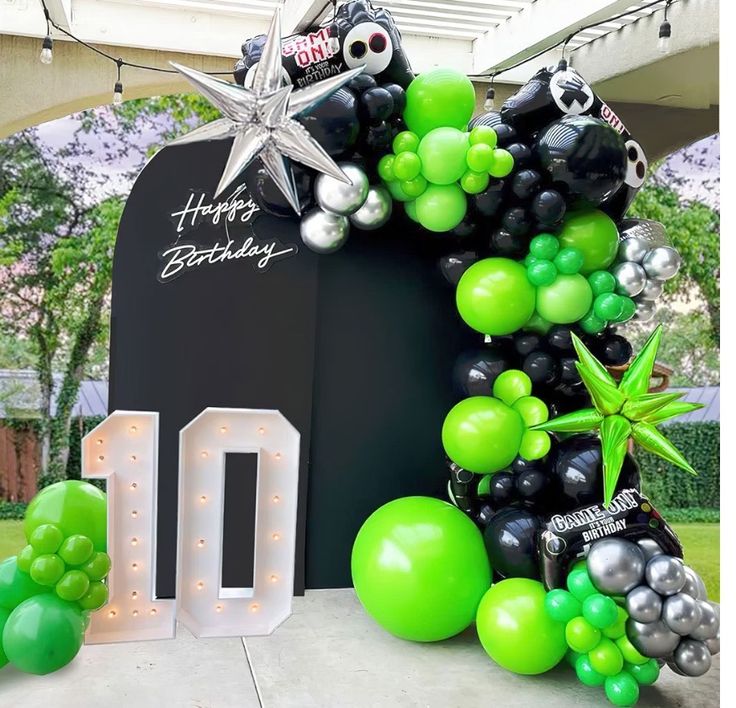 a balloon arch with balloons and decorations for a 10th birthday