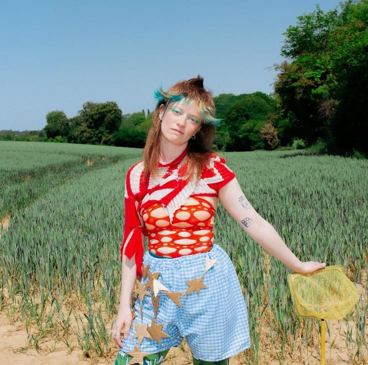 a woman standing in the middle of a field