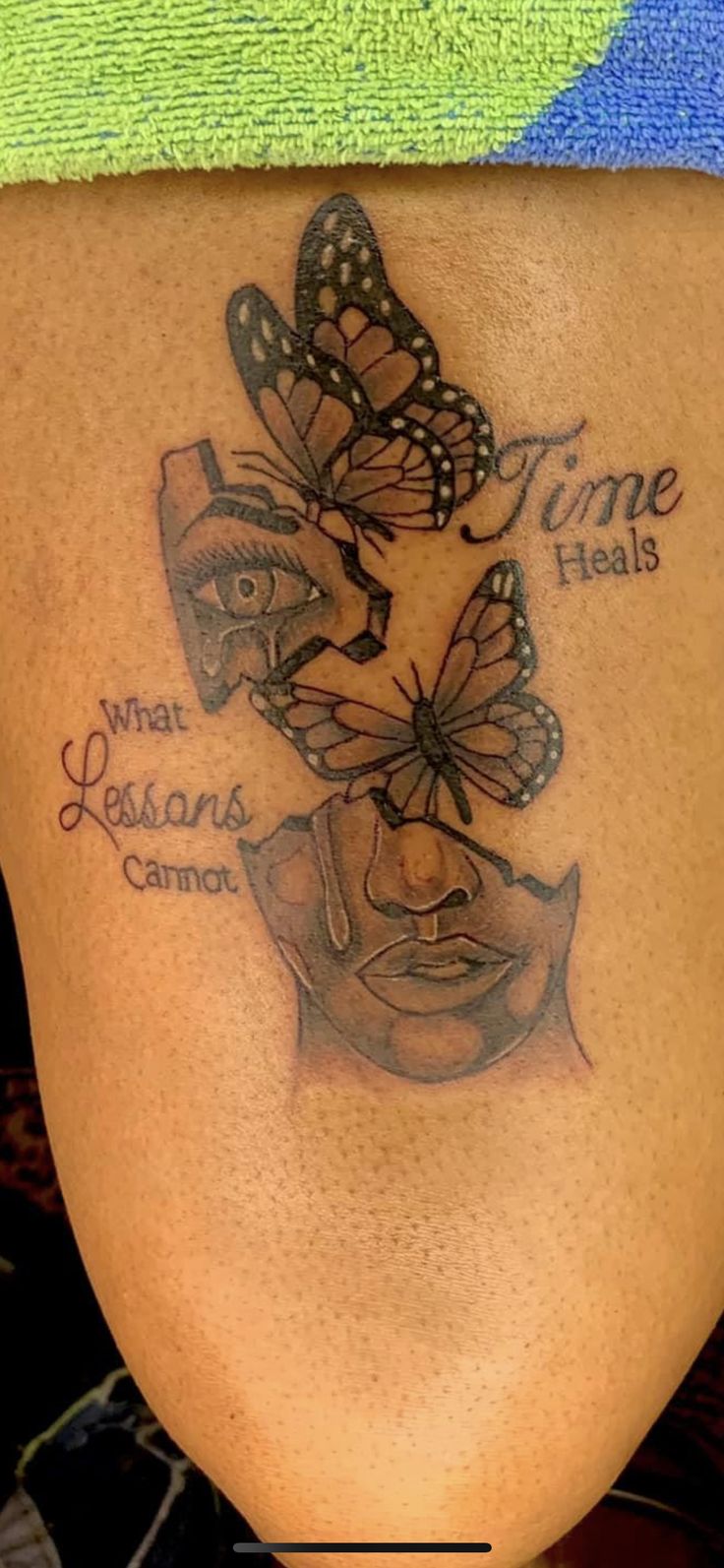 a woman's thigh with butterflies on it and the words time heals, what reason cannot