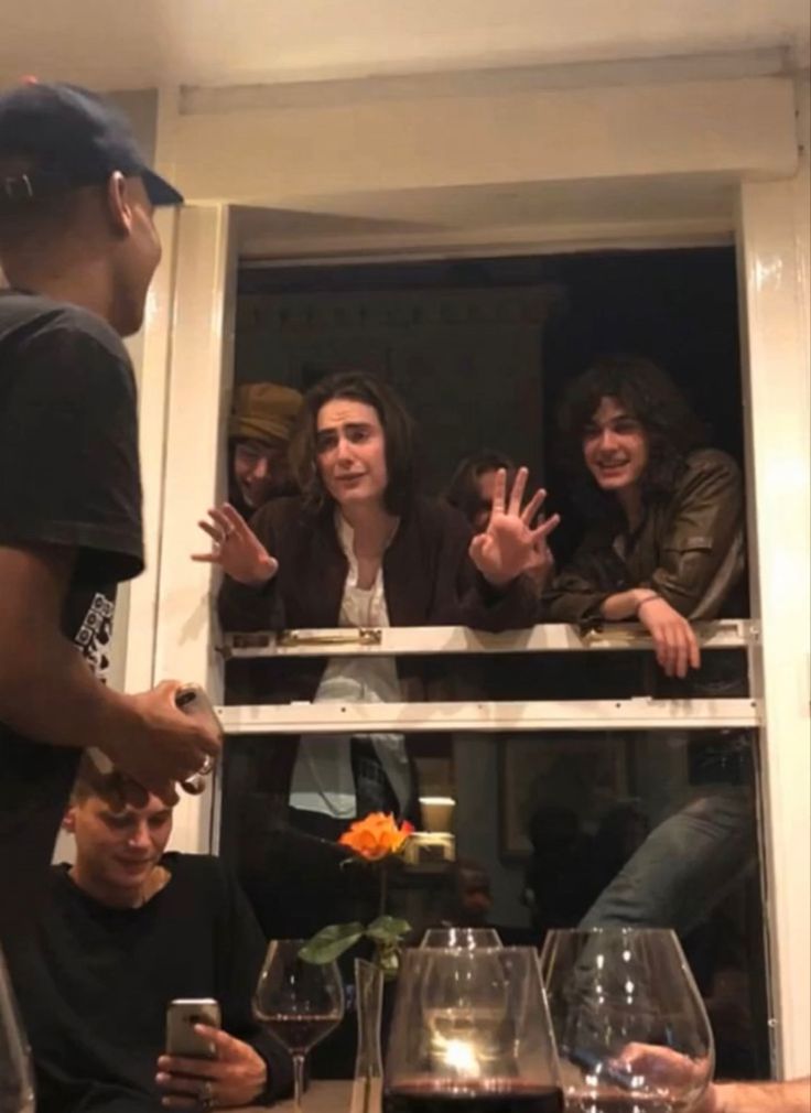 a group of people sitting around a table with wine glasses