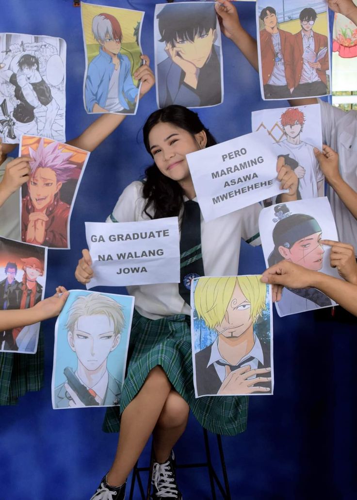 some people are holding up signs with anime characters on them