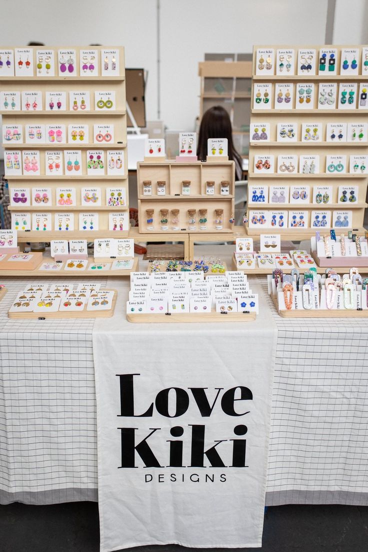 the love kiki designs booth is set up with cards and boxes on it's table