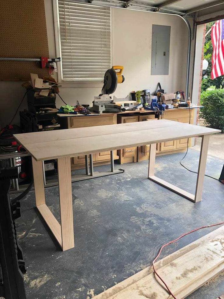 a workbench in a garage with an american flag on the wall